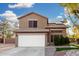 Two-story house with landscaped yard, driveway, and white garage door at 21054 N 74Th Ln, Glendale, AZ 85308