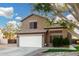 Two-story house with a white garage door and landscaped yard at 21054 N 74Th Ln, Glendale, AZ 85308