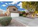 Two-story house with landscaped yard, driveway, and white garage door at 21054 N 74Th Ln, Glendale, AZ 85308