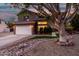 Two-story house with landscaped yard, driveway, and white garage door at dusk at 21054 N 74Th Ln, Glendale, AZ 85308