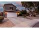 Two-story house with landscaped yard, driveway, and white garage door at dusk at 21054 N 74Th Ln, Glendale, AZ 85308