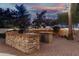 High-end outdoor kitchen with stonework and grilling station at 21054 N 74Th Ln, Glendale, AZ 85308