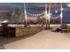 Elegant outdoor kitchen with stonework and bar seating at 21054 N 74Th Ln, Glendale, AZ 85308