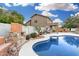 Relaxing pool area with a stone fireplace and patio at 21054 N 74Th Ln, Glendale, AZ 85308