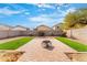 Artificial turf backyard with a fire pit and patio at 2119 W Vineyard Plains Dr, San Tan Valley, AZ 85144