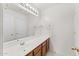 Bathroom with wood vanity, mirror, and tile floor at 2119 W Vineyard Plains Dr, San Tan Valley, AZ 85144