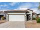 Single-story house with a two-car garage and desert landscaping at 21362 E Puesta Del Sol Rd, Queen Creek, AZ 85142