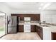 Kitchen with dark brown cabinets, stainless steel appliances, and backyard access at 21362 E Puesta Del Sol Rd, Queen Creek, AZ 85142