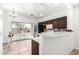 Kitchen with dark brown cabinets, stainless steel appliances, and backyard access at 21362 E Puesta Del Sol Rd, Queen Creek, AZ 85142