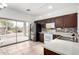 Kitchen with dark brown cabinets, stainless steel appliances, and backyard access at 21362 E Puesta Del Sol Rd, Queen Creek, AZ 85142