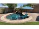 In-ground pool featuring a waterfall and two chairs at 21362 E Puesta Del Sol Rd, Queen Creek, AZ 85142