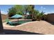 A beautiful pool area surrounded by trees and desert landscaping at 21362 E Puesta Del Sol Rd, Queen Creek, AZ 85142