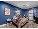 Stylish bedroom with leopard print bedding and a barn door at 2206 W Glendale Ave, Phoenix, AZ 85021