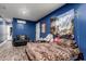 Serene bedroom with blue walls and a comfy armchair at 2206 W Glendale Ave, Phoenix, AZ 85021