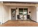 Front porch with gray door and wicker chairs at 2206 W Glendale Ave, Phoenix, AZ 85021