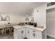 White kitchen island with seating and built-in storage at 2206 W Glendale Ave, Phoenix, AZ 85021