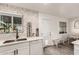 Modern kitchen with white cabinets, subway tile, and a farmhouse sink at 2206 W Glendale Ave, Phoenix, AZ 85021