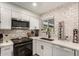 White kitchen with subway tile backsplash and stainless steel appliances at 2206 W Glendale Ave, Phoenix, AZ 85021