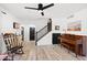 Spacious living room with wood-look floors and a piano at 2238 S Estrella Cir, Mesa, AZ 85202