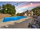 Inviting backyard pool with patio furniture and string lights at 2238 S Estrella Cir, Mesa, AZ 85202