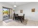 Dining area with four chairs and sliding glass doors to patio at 22402 W Harrison St, Buckeye, AZ 85326