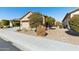 Tan house with a two-car garage and desert landscaping at 22402 W Harrison St, Buckeye, AZ 85326