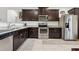 Kitchen with dark brown cabinets, granite counters and stainless steel appliances at 22402 W Harrison St, Buckeye, AZ 85326