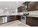 Modern kitchen with stainless steel appliances and granite countertops at 22402 W Harrison St, Buckeye, AZ 85326