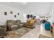 Open living room with neutral colored furniture and tile floors at 22402 W Harrison St, Buckeye, AZ 85326