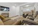 Open living room with neutral colored furniture and tile floors at 22402 W Harrison St, Buckeye, AZ 85326