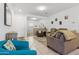 Open living room with neutral colored furniture and tile floors at 22402 W Harrison St, Buckeye, AZ 85326