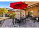 Covered patio with seating area, umbrella, and adjacent to house at 22402 W Harrison St, Buckeye, AZ 85326