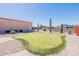 Backyard with putting green, cacti, and partial view of neighboring homes at 2263 N Trekell Rd, Casa Grande, AZ 85122