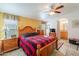 Cozy bedroom with wood furniture and a ceiling fan at 2263 N Trekell Rd, Casa Grande, AZ 85122