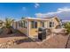 Tan home exterior with covered patio and grill, showcasing curb appeal at 2263 N Trekell Rd # 72, Casa Grande, AZ 85122