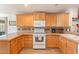 Kitchen with light wood cabinets and white appliances at 2263 N Trekell Rd, Casa Grande, AZ 85122