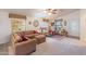 Spacious living room with brown couches and a ceiling fan at 2263 N Trekell Rd # 72, Casa Grande, AZ 85122