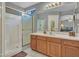 Clean bathroom with shower, vanity, and wooden cabinets at 22667 N 30Th Ave, Phoenix, AZ 85027