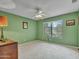 Green-walled bedroom with window and ceiling fan at 22667 N 30Th Ave, Phoenix, AZ 85027