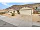 Front view of a house with a garage and desert landscaping at 22667 N 30Th Ave, Phoenix, AZ 85027