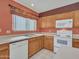 Bright kitchen with wood cabinets, white appliances, and ample counter space at 22667 N 30Th Ave, Phoenix, AZ 85027