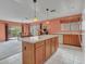 Kitchen with island, wood cabinets, and view into the dining area at 22667 N 30Th Ave, Phoenix, AZ 85027