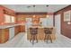 Galley style kitchen with wood cabinets, island, and white appliances at 22667 N 30Th Ave, Phoenix, AZ 85027