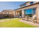 Outdoor patio with seating area, adjacent to the house and lawn at 23071 N 98Th Dr, Peoria, AZ 85383