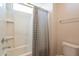 Clean bathroom with a shower/tub combo and gray striped shower curtain at 23071 N 98Th Dr, Peoria, AZ 85383