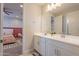 Double vanity bathroom with white cabinets and a view of the bedroom at 23071 N 98Th Dr, Peoria, AZ 85383