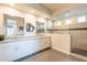 Double vanity bathroom with large walk-in shower and modern fixtures at 23071 N 98Th Dr, Peoria, AZ 85383