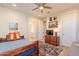 Bright bedroom with wood bed frame, dresser, and ceiling fan at 23071 N 98Th Dr, Peoria, AZ 85383