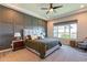 Spacious bedroom with large window, gray accent wall, and carpeted floors at 23071 N 98Th Dr, Peoria, AZ 85383