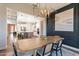 Open dining area with modern chandelier and view into kitchen at 23071 N 98Th Dr, Peoria, AZ 85383